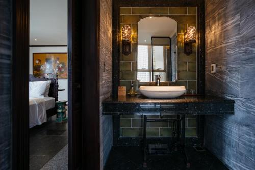 a bathroom with a sink and a mirror at Amanaki Thao Dien in Ho Chi Minh City