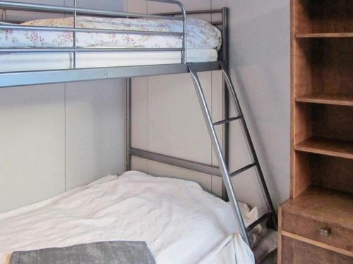 a bunk bed with a ladder in a room at Holiday home SÄLEN in Stöten