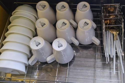 a bunch of mugs sitting in a drawer at 林莊園包棟別墅Skydoorzi Villa in Guoxing