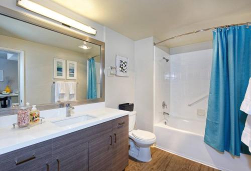 a bathroom with a sink and a toilet and a tub at Marina Del Rey Resort Style Apartment I Free Parking in Los Angeles