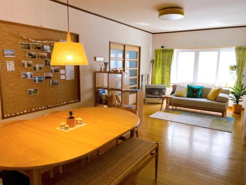 a living room with a table and a couch at LuLu Stay in Wakkanai