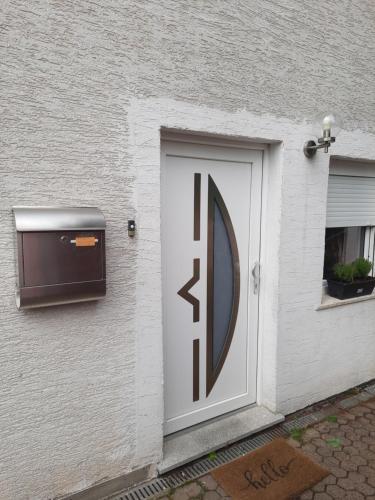 a white door on a building with a mailbox at Fewo klein aber fein in Mittelbexbach
