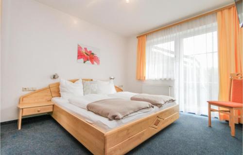 a bedroom with a bed and a large window at Cozy Apartment In Viehhofen With Ethernet Internet in Viehhofen