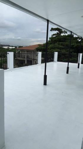 a white patio with a view of the ocean at White Sands Villas Maribago Lapu Lapu Cebu Tourist Area in Maribago