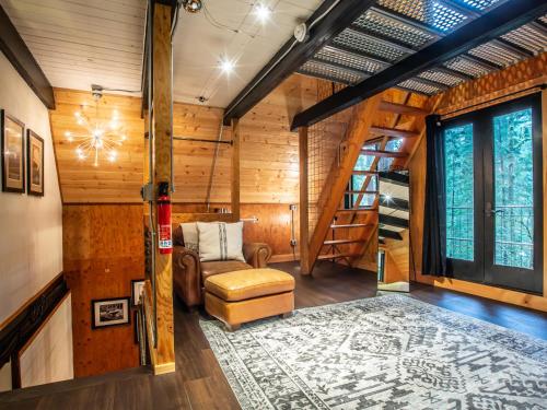 a room with a couch and a staircase in a house at Treetop Hideaway, Sleeps 2 in Glacier