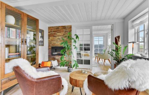 a living room with leather chairs and a table at Awesome Home In Sydals With Wifi in Ertebjerg