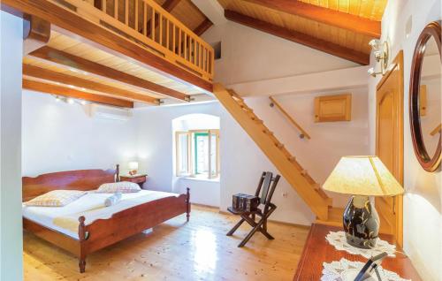 a bedroom with a bed and a staircase at Nice Home In Tucepi With 3 Bedrooms, Sauna And Wifi in Tučepi