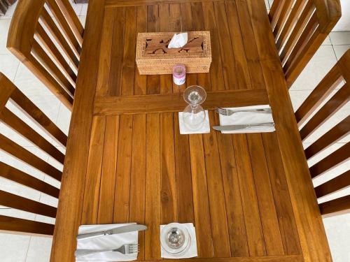 an overhead view of a wooden table with utensils at The Hill View Lombok in Kuta Lombok