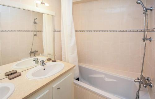 a bathroom with a sink and a shower and a tub at Nice Home In Aigues-mortes With Kitchen in Aigues-Mortes