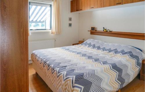 een slaapkamer met een bed met een blauw en wit dekbed bij Chalet 5 in Oosterwolde