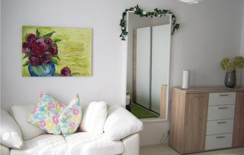 a living room with a white couch and a mirror at Pet Friendly Apartment in Waltershausen