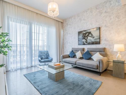 a living room with a couch and a horse painting on the wall at Chic 1BR in Park Heights 2 - Dubai Hills in Dubai