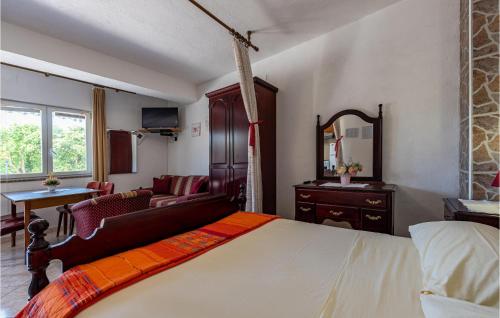 a bedroom with a bed and a desk and a mirror at Stunning Apartment In Pag With Wifi in Pag