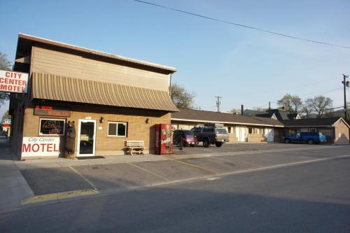 a store on the side of a street with a gas station at City Center Motel in Missoula