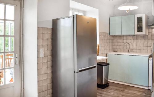 a stainless steel refrigerator in a kitchen at 3 Bedroom Beautiful Home In Lanvellec in Lanvellec