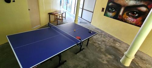a ping pong table in a room with a painting at Centerpoint Hotel & Plaza in Thongsala