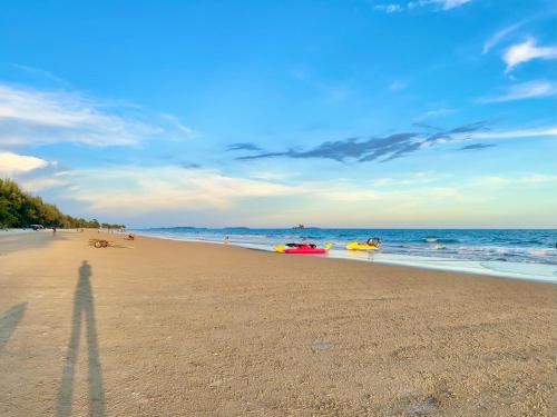 a beach with a group of people in the water at Mantra Beach Condominium Suite - Mae Phim in Ban Tha Fat