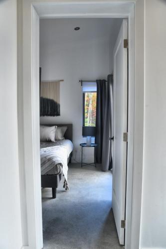 a bedroom with a bed and a window at KALLM-Mont-Tremblant chalet with hot tub, pond & beach on private 7acre estate in Lac-Superieur