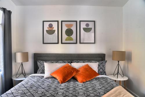 a bedroom with a bed with three pictures on the wall at KALLM-Mont-Tremblant chalet with hot tub, pond & beach on private 7acre estate in Lac-Superieur