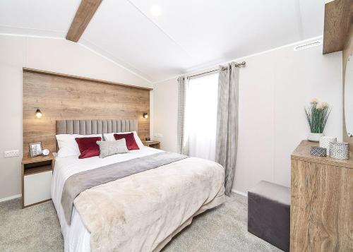 a bedroom with a large bed and a window at Witton Castle Country Park in Bishop Auckland