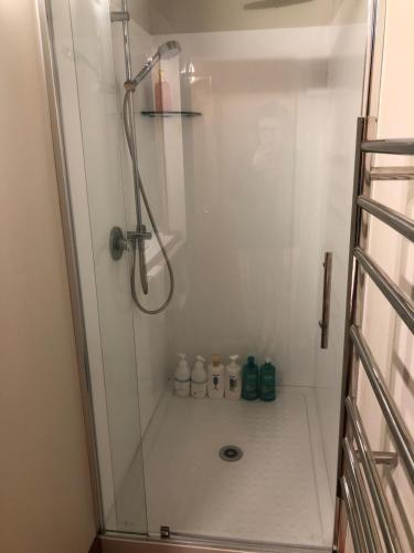 a shower with a glass shower stall in a bathroom at Summerfields B & B in Cambridge
