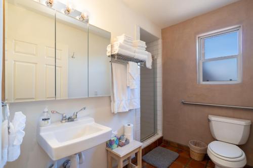 a bathroom with a sink and a toilet and a window at Casa Columbia, 1 Bedroom, Near Plaza, Centrally Located, Wi-Fi, Sleeps 2 in Santa Fe