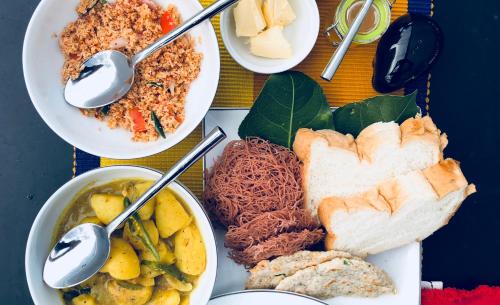 a table with plates of food and bowls of food at Big Game - Udawalawe by Eco Team in Udawalawe