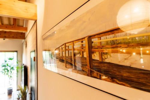 a painting hanging on a wall in a room at The Villa Miyako in Hirara