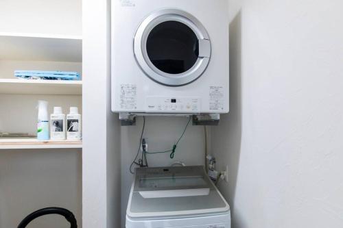 a washer and dryer in a corner of a room at The Villa Miyako in Hirara