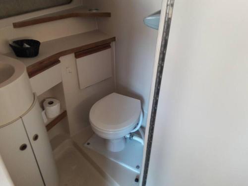 a small bathroom with a toilet and a sink at Yacht Stay Providence Marina in Providence