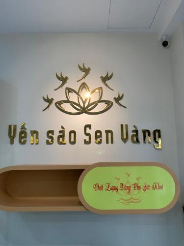 a sign on a wall with a lotus flower and birds at Golden Lotus Homestay Phú Quốc in Phu Quoc