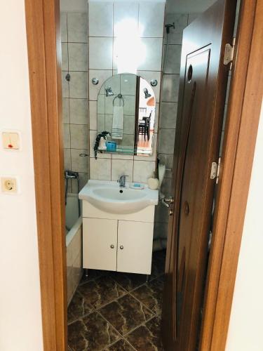 a bathroom with a sink and a mirror at Ana-Maria Home in Râmnicu Vâlcea
