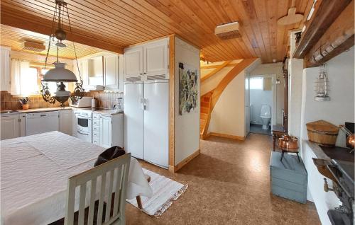 a kitchen with a white refrigerator in a room at Nice Home In Markaryd With Wifi in Markaryd