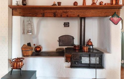 a kitchen with a stove with pots on it at Nice Home In Markaryd With Wifi in Markaryd