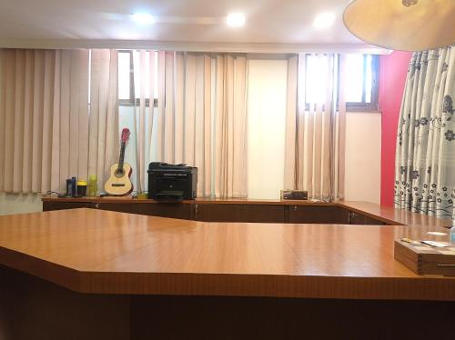 a room with a table with a guitar in it at Janaki House in Kathmandu