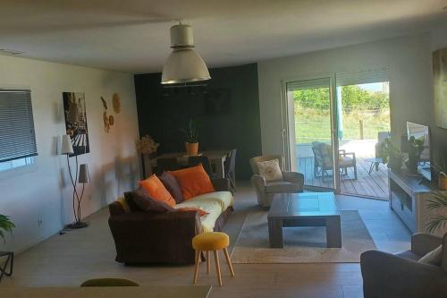 a living room with a couch and a table at Maison moderne dans la drome des collines in Bren