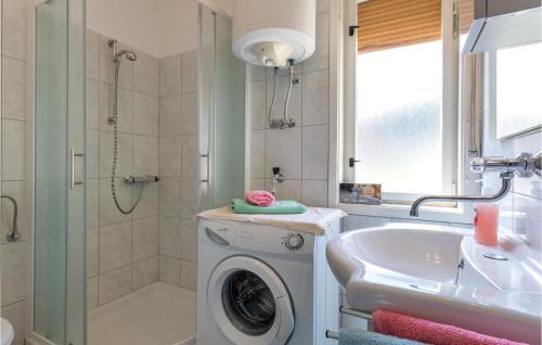 a bathroom with a washing machine and a sink at Nice Apartment In Marcana With Wifi in Marčana