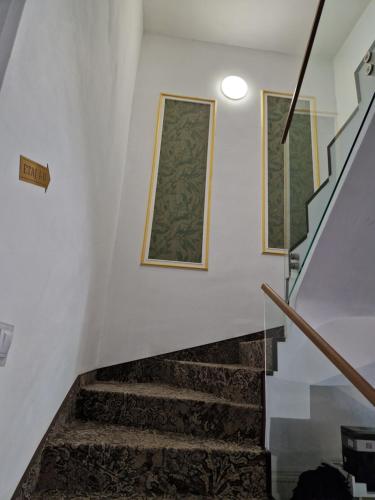 a staircase with two pictures on the wall at Caprice Deluxe Accomodation in Drobeta-Turnu Severin