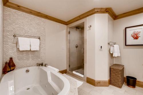 a bathroom with a large tub and a shower at 1-Vail Mountain View 403 in Vail