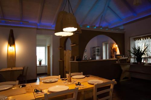 a dining room with a table and a blue light at Fexada Home in Vama