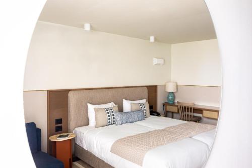 a bedroom with a bed and a desk at King Solomon Hotel Tiberias in Tiberias