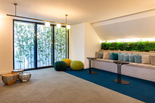 a lobby with a large window with green plants at King Solomon Hotel Tiberias in Tiberias