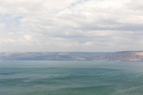 a view of a large body of water with mountains at King Solomon Hotel Tiberias in Tiberias