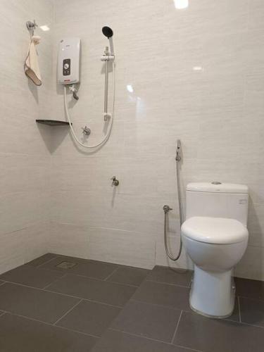 a bathroom with a shower and a toilet at Guesthouse 26 Villa/Sejati/Mile7 in Sandakan
