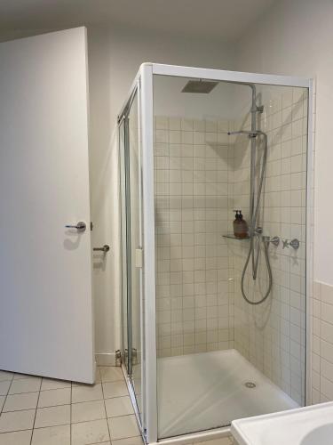 a shower with a glass door in a bathroom at Sunrise @ Breakers in Lorne