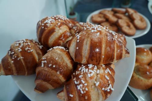 a plate of pastries and donuts on a table at Hotel Parco Delle Agavi in Ischia
