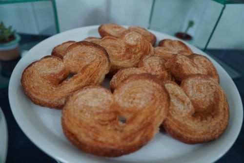 a pile of donuts on a plate on a table at Hotel Parco Delle Agavi in Ischia