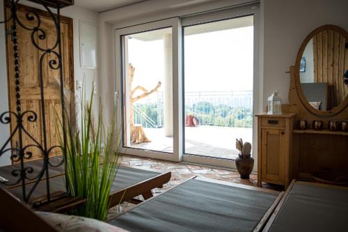 a room with a large sliding glass door with a mirror at Kellerstöckl in Leutschach