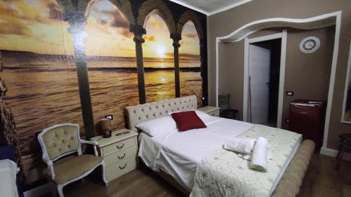 a bedroom with a bed and a painting on the wall at claire de lune in Cagliari