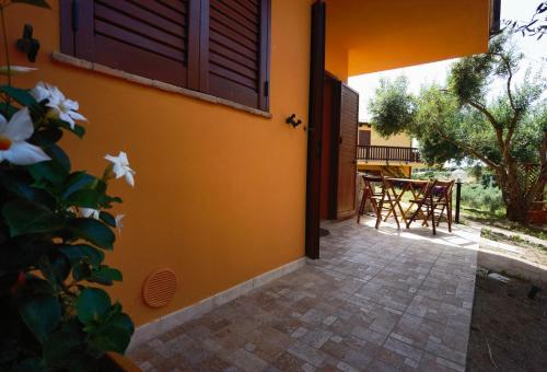 an open door of a house with a patio at La Corte degli Ulivi - Albergo Rurale in Tresnuraghes